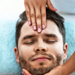 Picture of handsome man having massage in spa salon